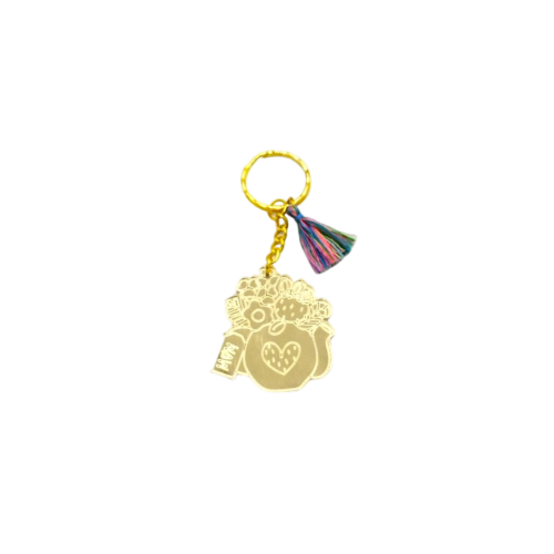 Keychain made from gold mirror plexiglass, featuring a pitcher with flowers and a colorful tassel. - 